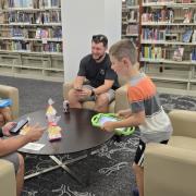 People playing Pokemon Go in the library