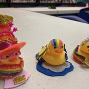 Three rubber duckies dressed up in fun accessories