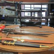 A weapons exhibit shows off various swords.