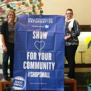 Library staff with Small Business Saturday sign