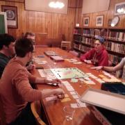 Students playing a board game in the library