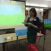 Becky O'Neil shows the class how to mix and blend paint