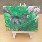 Photo of art canvas with painting of wolf and three pigs