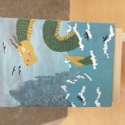 Photo of art canvas with painting of a dragon in the ocean
