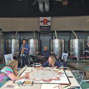 Attendees coloring the mural in the distillery