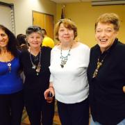 Creative Aging program participants show off their reclaimed jewelry. 