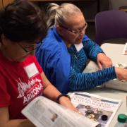Two participants use reclaimed objects to create jewelry during a Creative Aging session.