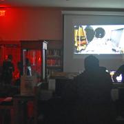 Photograph of program participants watching videos inside.