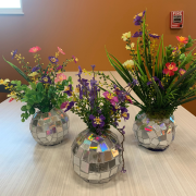 Photograph of three completed disco ball vases with faux flowers.