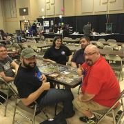 Group around a table playing Dice Tower