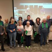 group photo of senior citizens holding weights