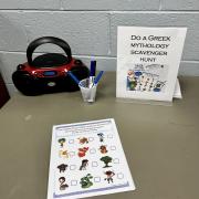 Photograph of an event station - Greek Mythology Scavenger Hunt set up with scavenger hunt print-out, markers and CD player.