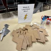Photograph of an event station - Make a Lightning Bolt set up with pre-cut lightning bolt shapes and craft materials