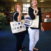 Library staff modeling Shop Small tote bags