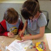 Two participants collaborate on modeling clay for their stop-motion movie.