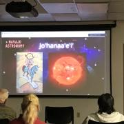  Photo from Navajo Astronomy. Screen shows the slide of presentation with four people facing the screen.