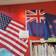 Photograph of New Zealand and USA flags on display in library