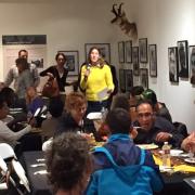 A person stands up to speak at the Breaking Bread with Refugees event.