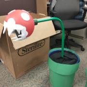 foam sphere decorated into piranha plant head and green pole sitting in planter pot
