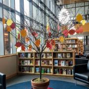 Picture of tree in library with paper leaves hanging