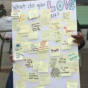 Post-it wall asking "What do you love about yourself?" with responses