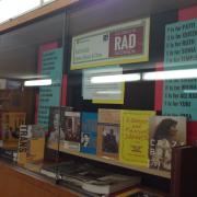 Display case of books and posters about Rad Women