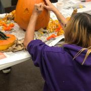 Woman carving a pumpkin