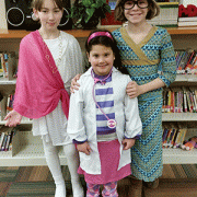 Dress like a book character day - three children dressed as the athena goddess, Doc-McStuffins, and Junie B Jones