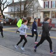 Participants run through town during the Run for Reading 5K.
