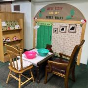 Photo shows a table inside the library decorated to the theme of the StoryWalk book: Santa Clause and the Three Bears