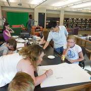 Teens drawing their electric paint designs