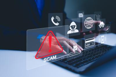 laptop open with various floating computer icons including one that says "scam!"