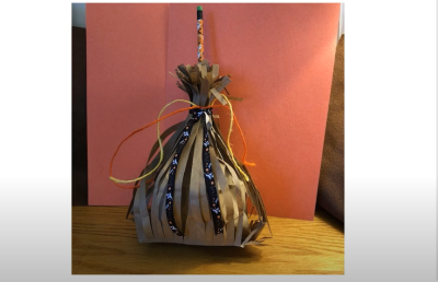 Photograph of a completed Witch Broom Candy Bag made of a paper bag.