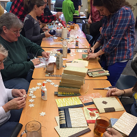 people at table making crafts