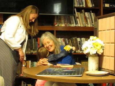 Author Elizabeth Berg hugs a girl at the library