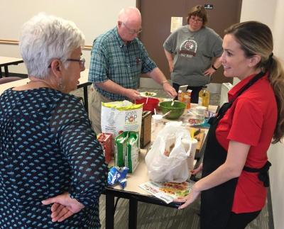 A dietician speaking to people around a table