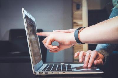 Two people looking at laptop