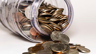 Jar with coins spilling out of it