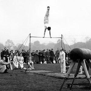 In the months leading up to the 1948 Games, members of the British Olympic Team of Gymnasts practise on the high bar in Hyde Park.