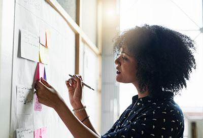 Woman writing on a whiteboard