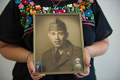 Woman holding framed family photograph