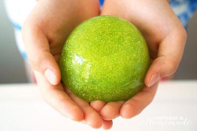 Hands holding shamrock slime