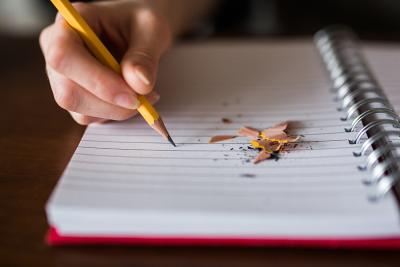 A broken pencil on a notepad